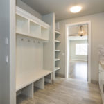 White built-in storage in laundry room. PNW Closets designs and installs quality laundry room & mudroom storage in Portland OR and Vancouver WA.