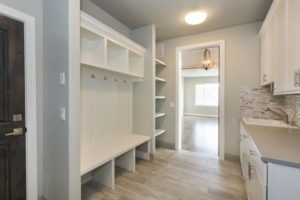 White built-in storage in laundry room. PNW Closets designs and installs quality laundry room & mudroom storage in Portland OR and Vancouver WA.