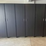 Professionally installed black garage cabinets, doors closed