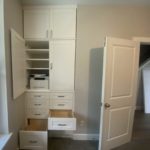 Modern new white colored office cabinets, doors open