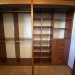 Brown hallway closet shelves and drawers