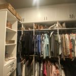 Walk-in closet with clothing and items on the shelf