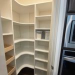 Professionally installed pantry shelves in a kitchen closet