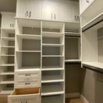 Custom design walk-in closet shelves, cabinets and open drawers