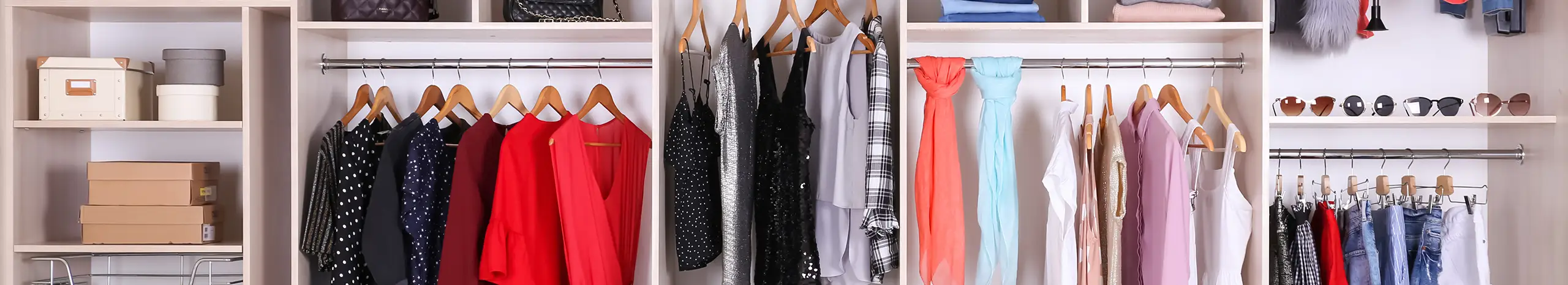 Custom walk-in closet with organized hanging space and accessory shelving