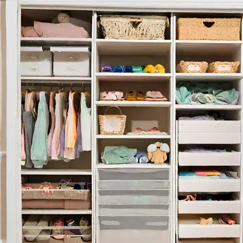 Custom reach-in closet with hanging space, shelving, and storage baskets