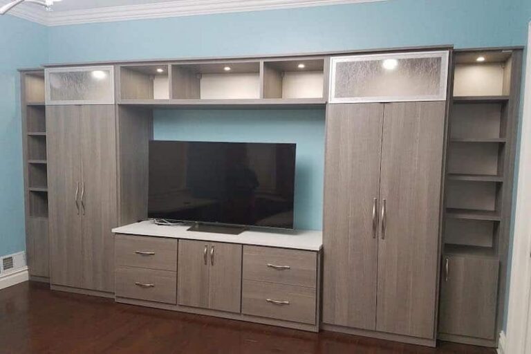 Custom built-in entertainment center with TV console and tall storage cabinets