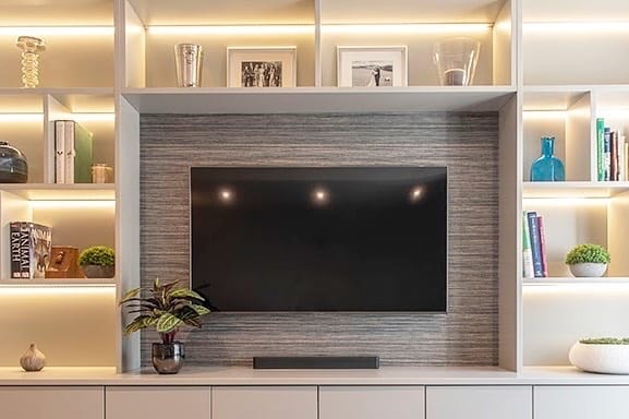Built-in media wall with LED accent lighting and display shelves