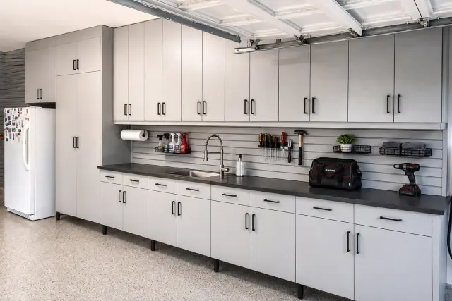 Light grey garage cabinets with a built-in sink and countertop