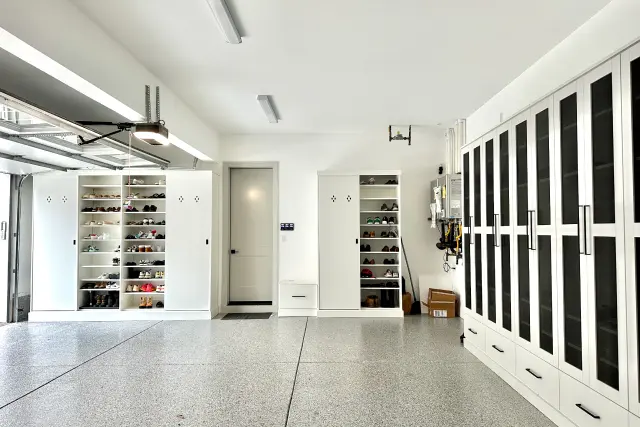 White custom garage cabinets with built-in shoe storage shelves